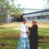 Julia Morton-Marr presents an ISPG pin in front of the new Christ the King School in Whitehorse.  This was the second Peace Garden for this school.  The first garden was at a previous building in downtown Whitehorse.