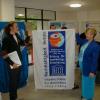 Eric Schneider and Julia Morton-Marr holding the UNESCO banner presented to Eric for his 'Positive News Youth Views' PNYV program in Berlin, October 24, 2005.  Eric maintained the IHTEC website for many years prior to 2012.